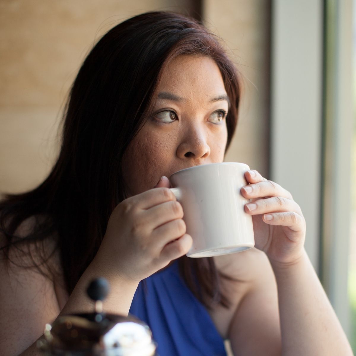drinking coffee in a white mug